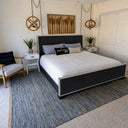 Belffin-Dark-frame-bed-with-white-bedding-sail-away-pillow-white-nightstands-striped-accent-chair-and-blue-area-rug